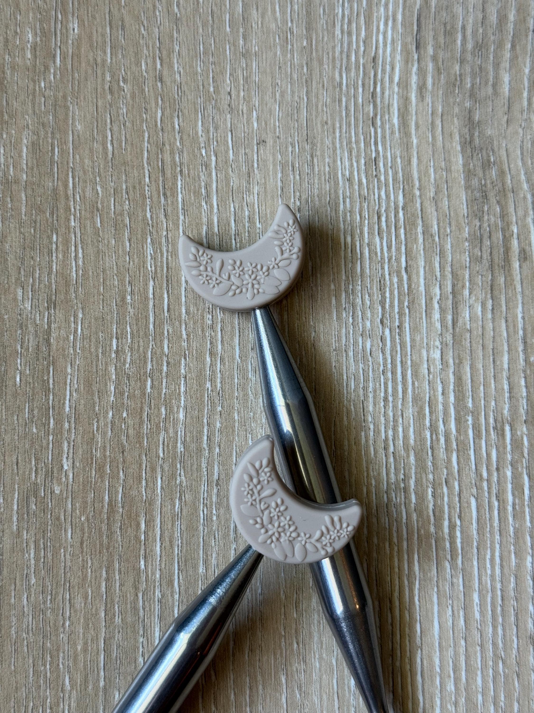 Crescent moon needle stoppers for knitting needles