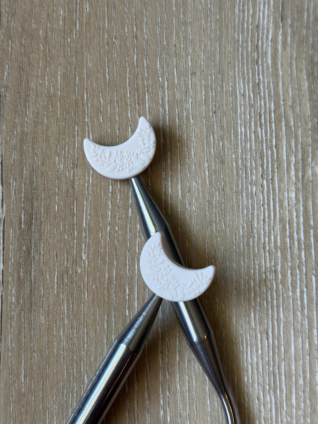 Crescent moon needle stoppers for knitting needles