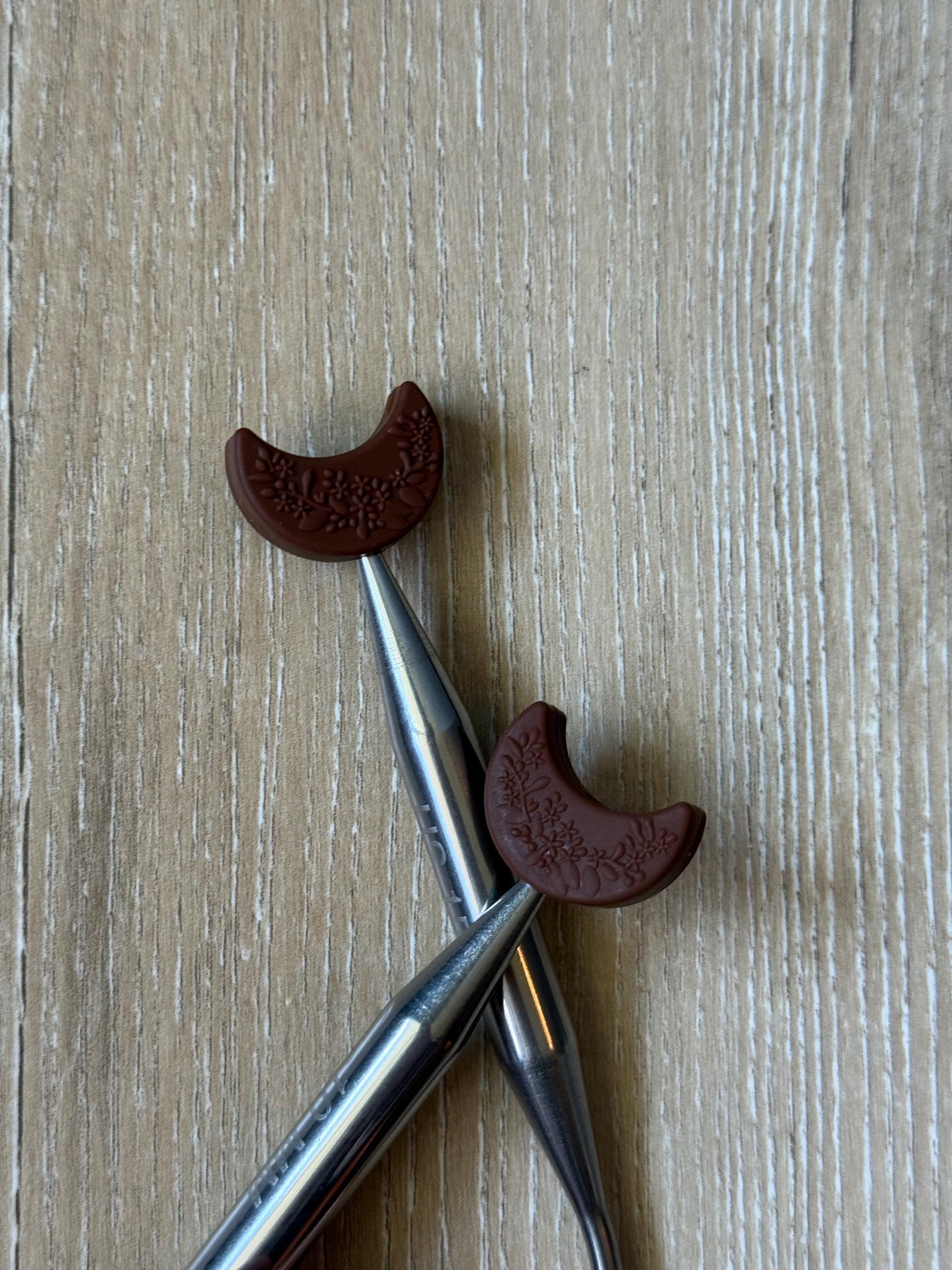Crescent moon needle stoppers for knitting needles