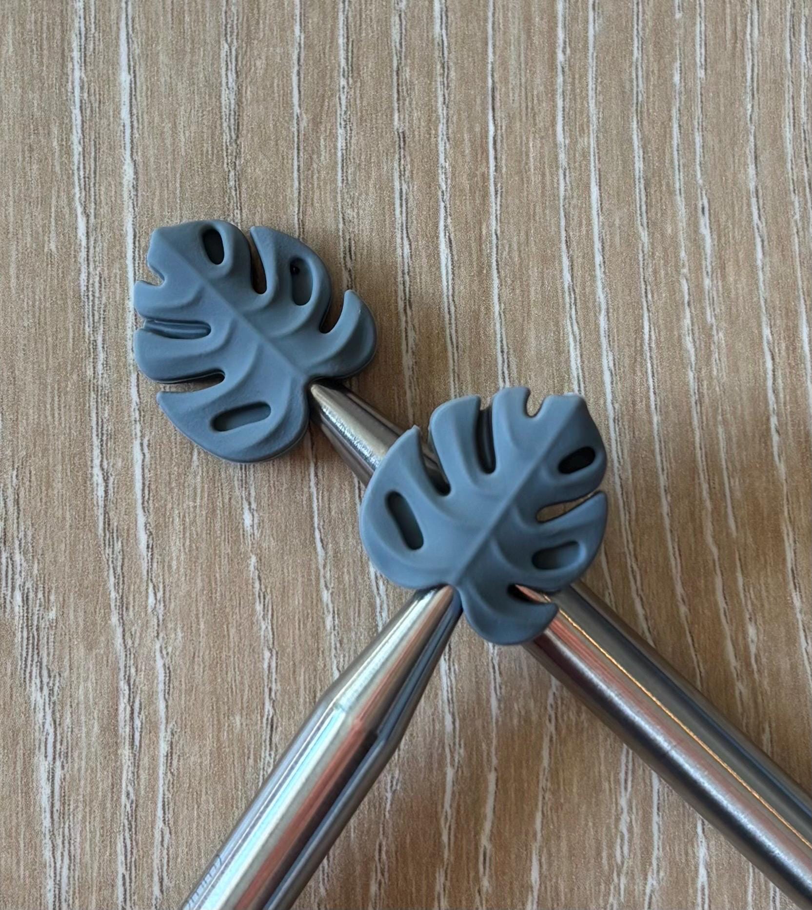 Leaf needle stoppers for knitting needles