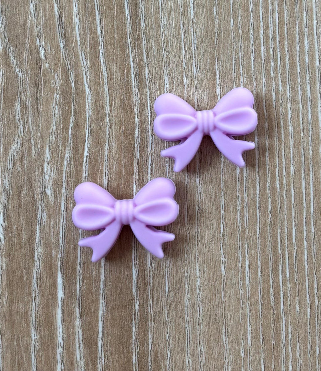 Bow needle stoppers for knitting needles