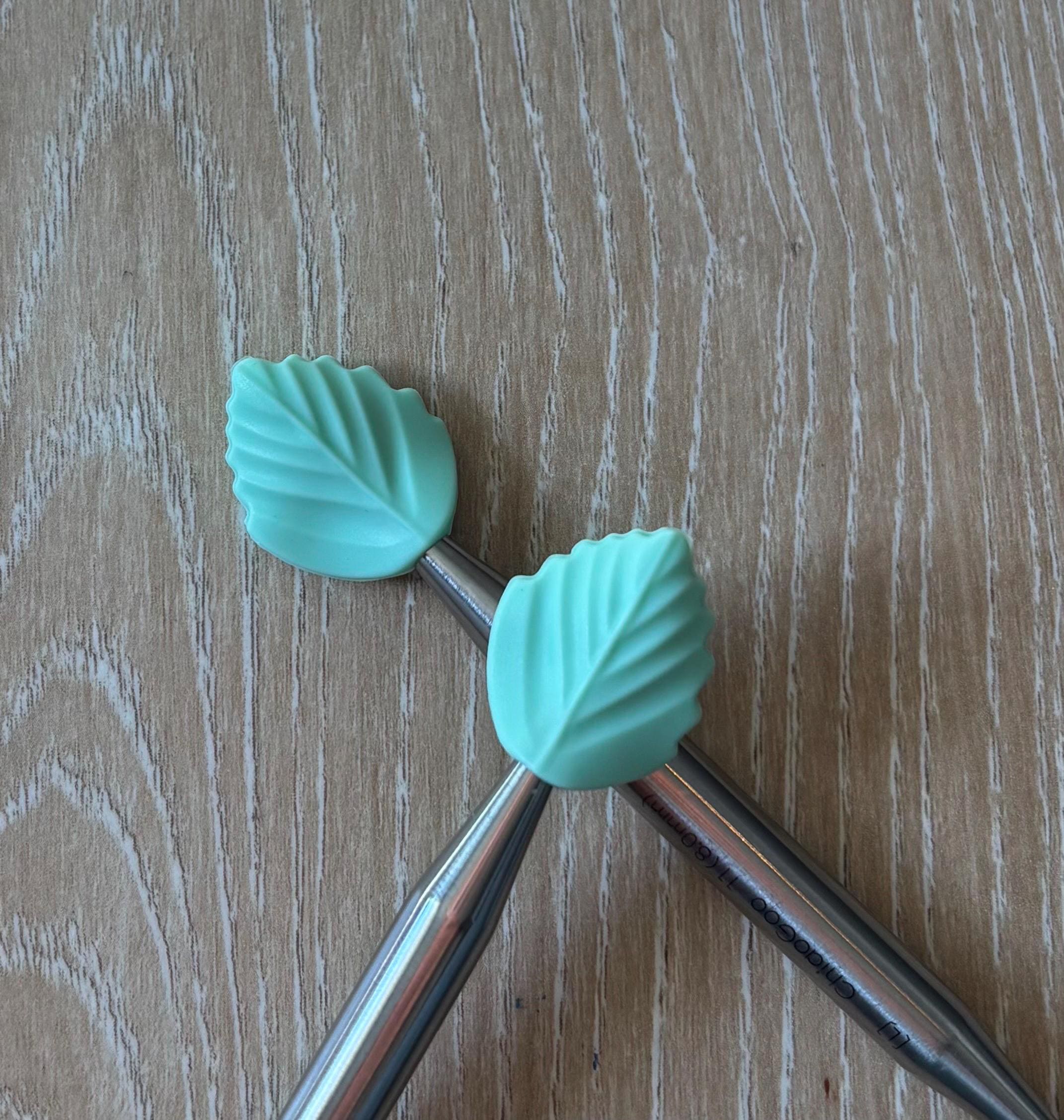 Leaf needle stoppers for knitting needles