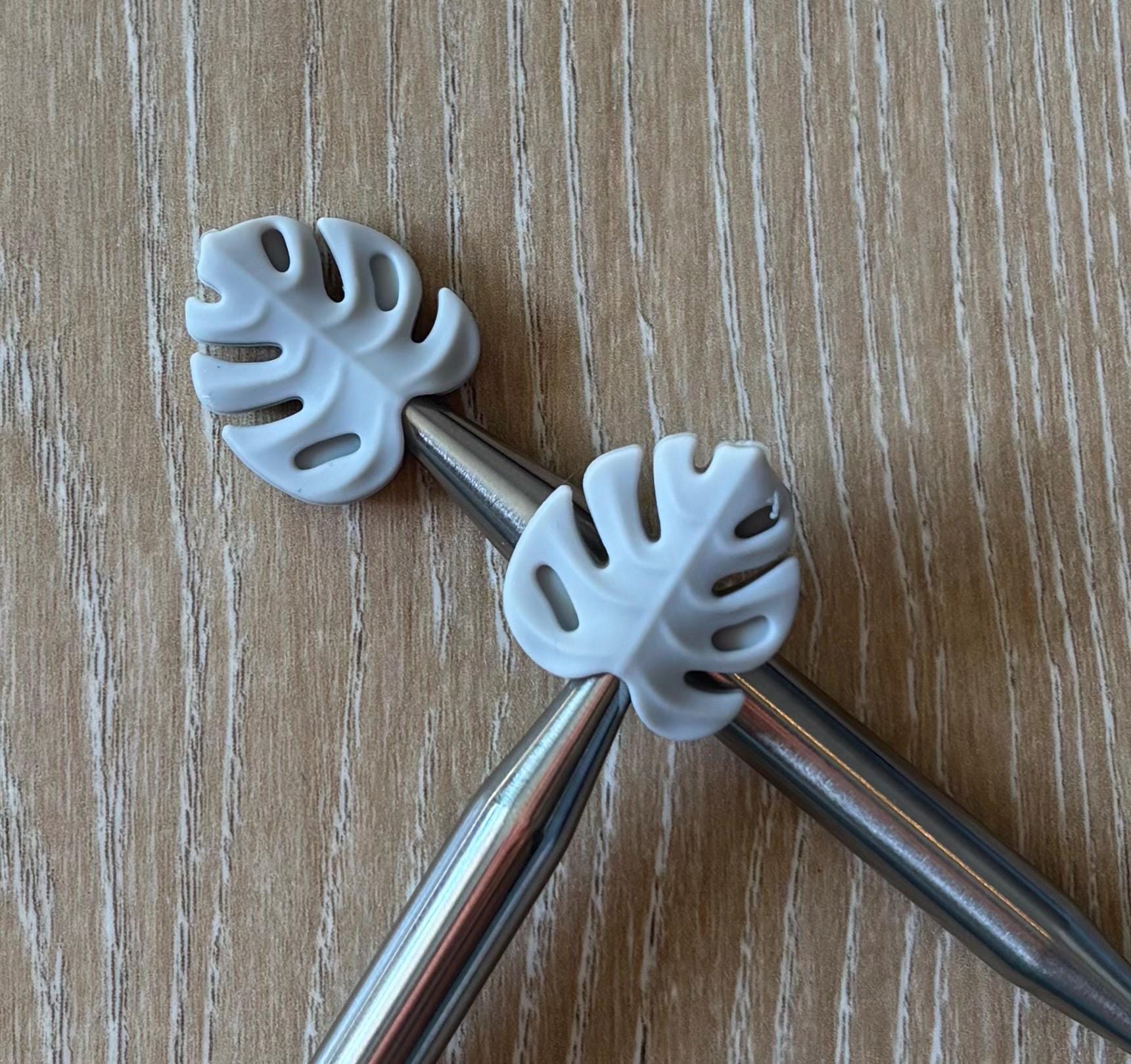 Leaf needle stoppers for knitting needles