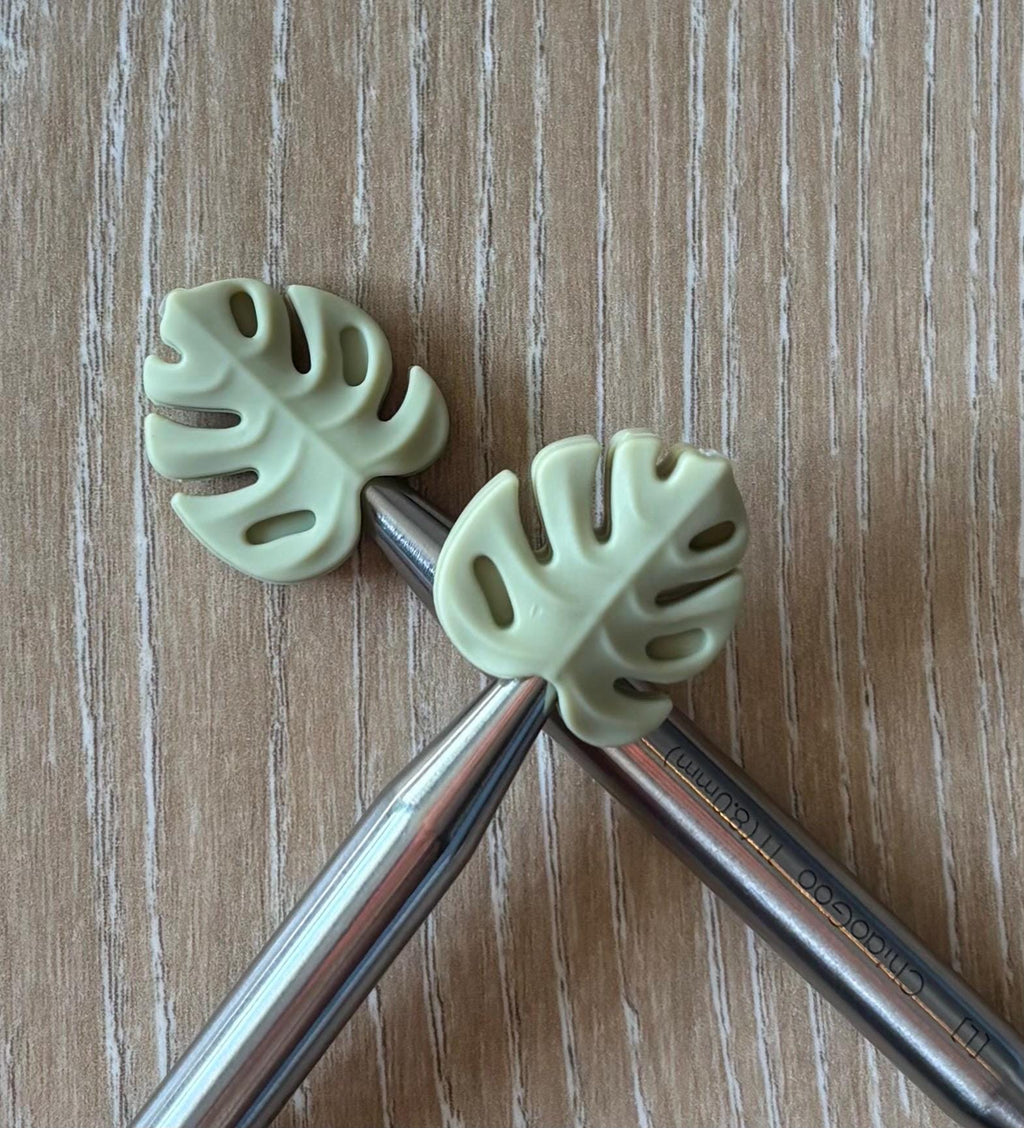 Leaf needle stoppers for knitting needles