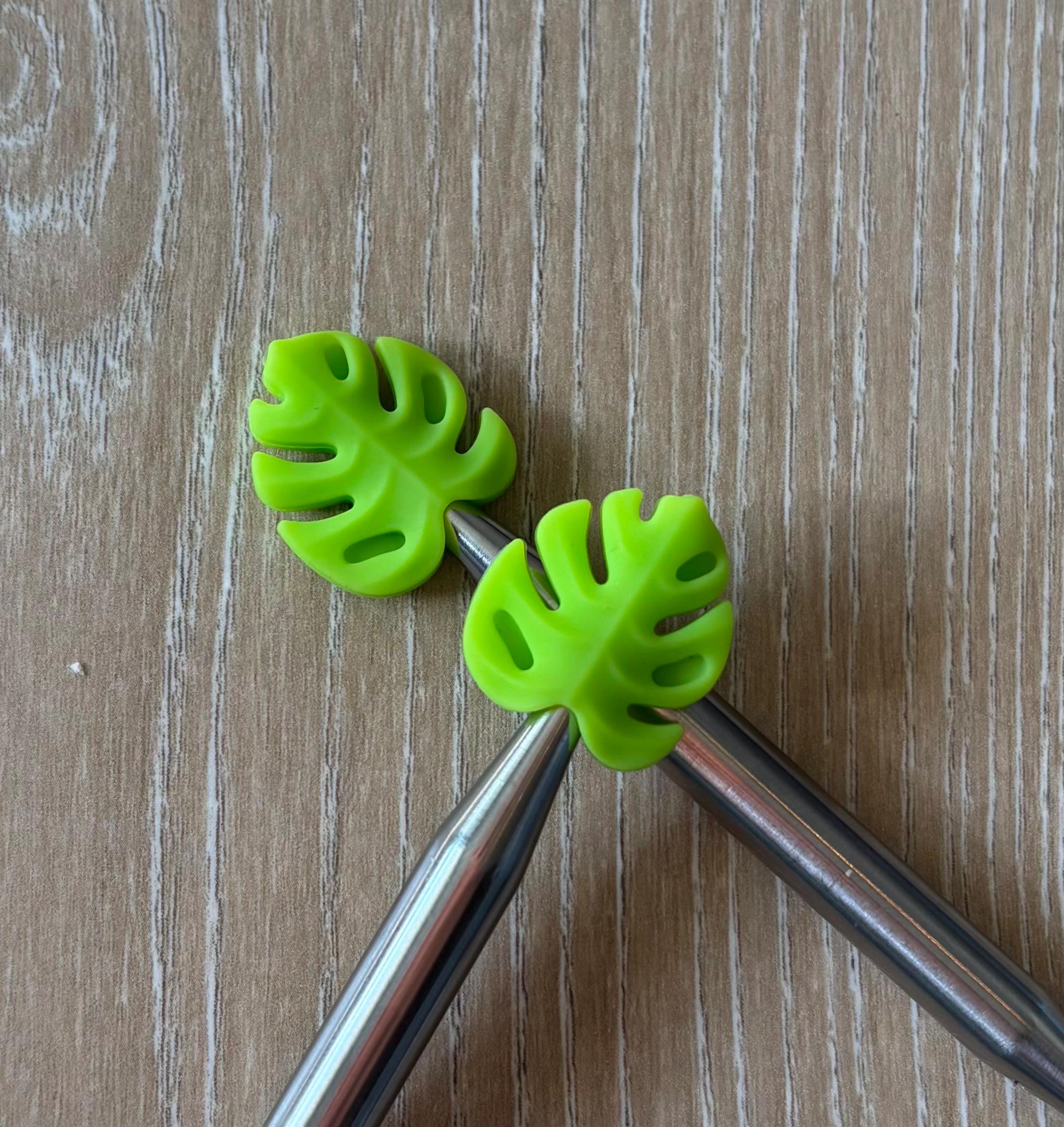 Leaf needle stoppers for knitting needles