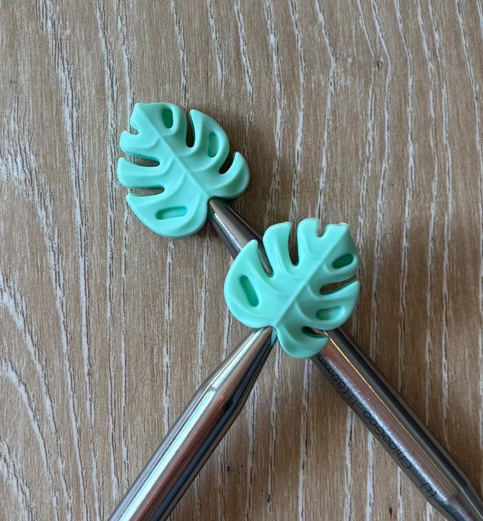 Leaf needle stoppers for knitting needles