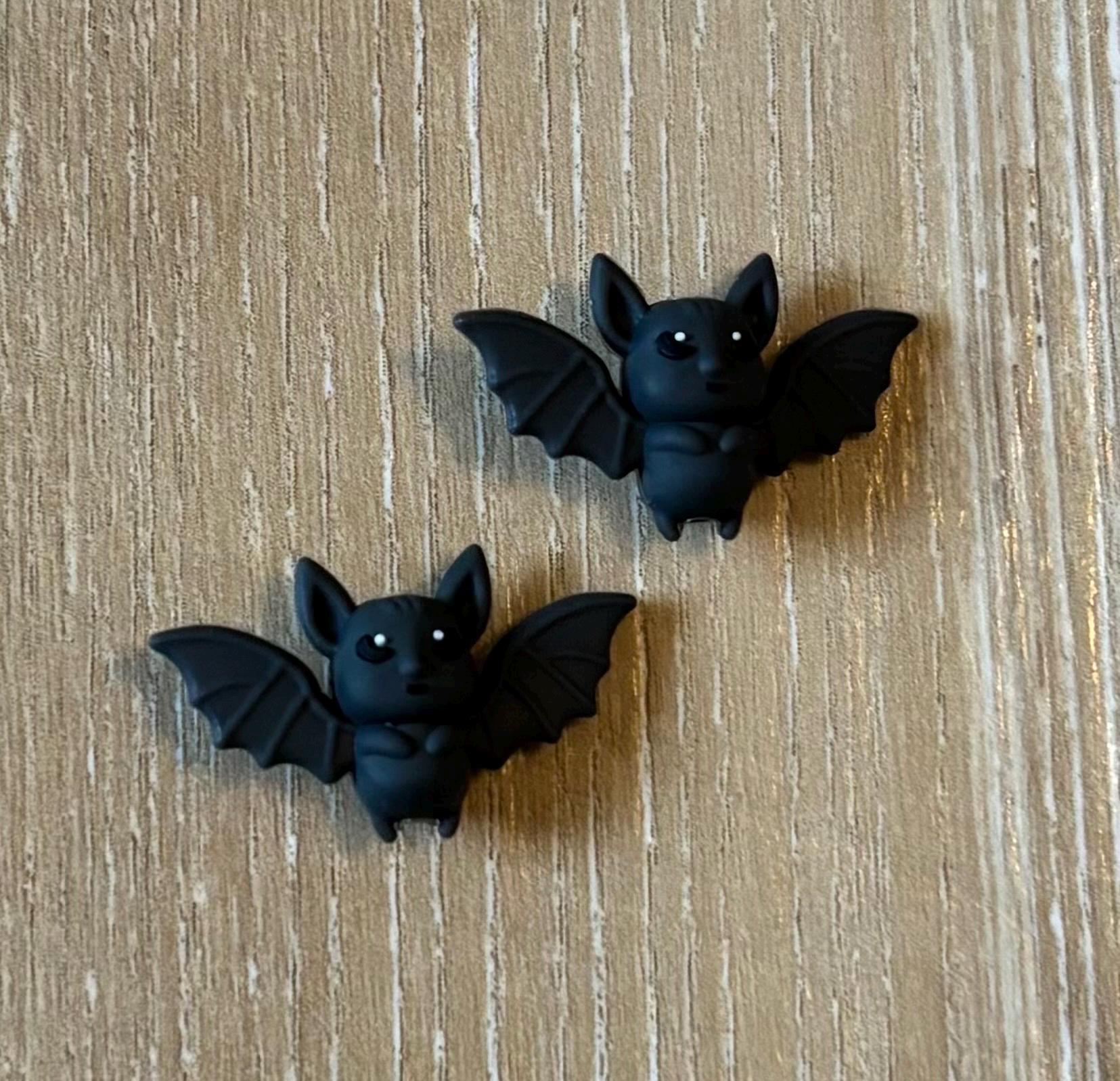 Bat needle stoppers for knitting needles