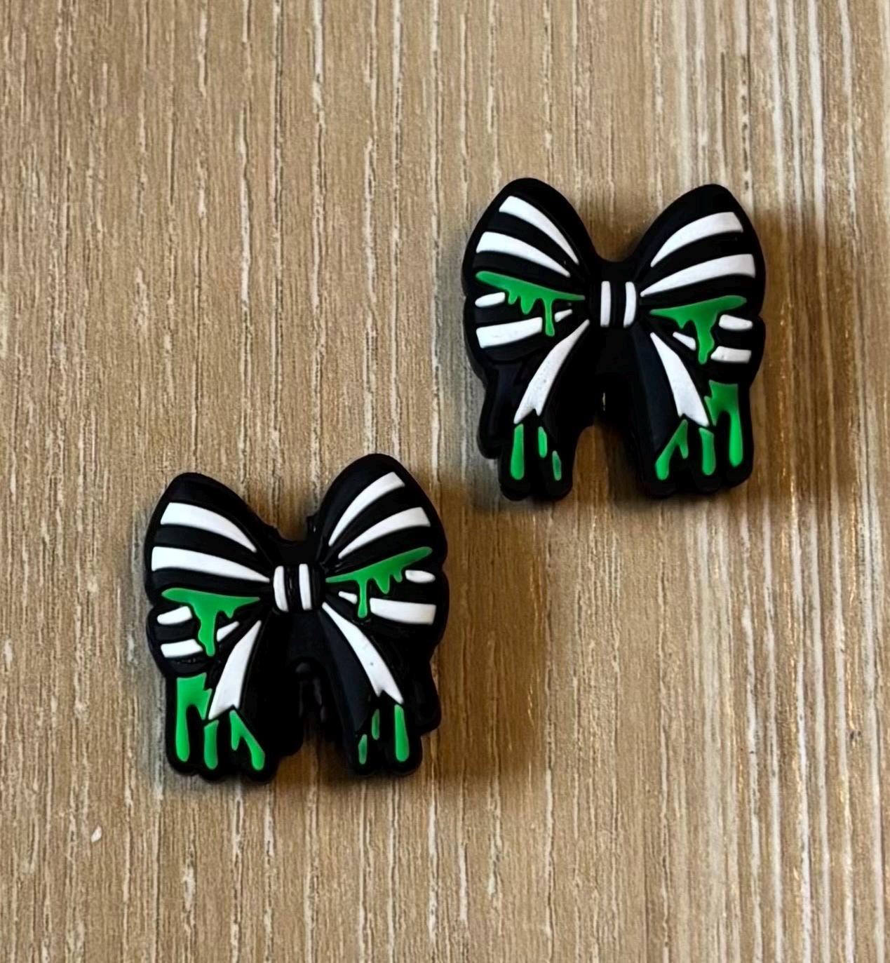 Bow needle stoppers for knitting needles