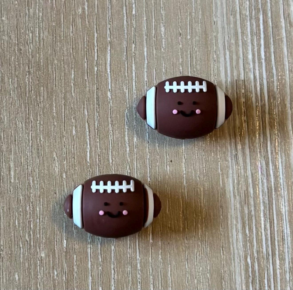 Football needle stoppers for knitting needles
