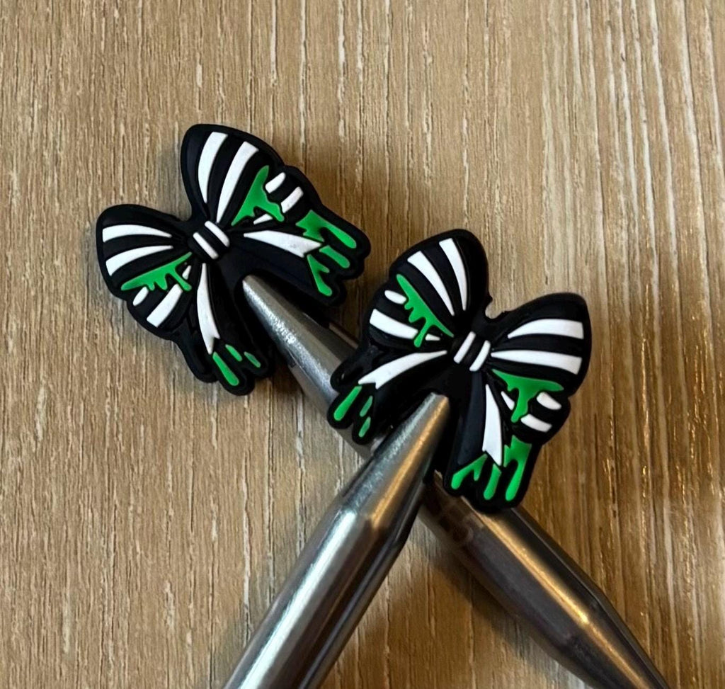 Bow needle stoppers for knitting needles