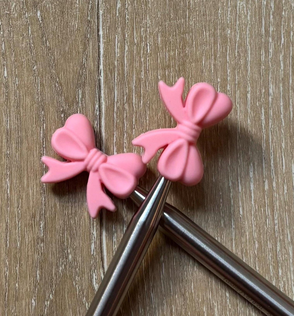 Bow needle stoppers for knitting needles