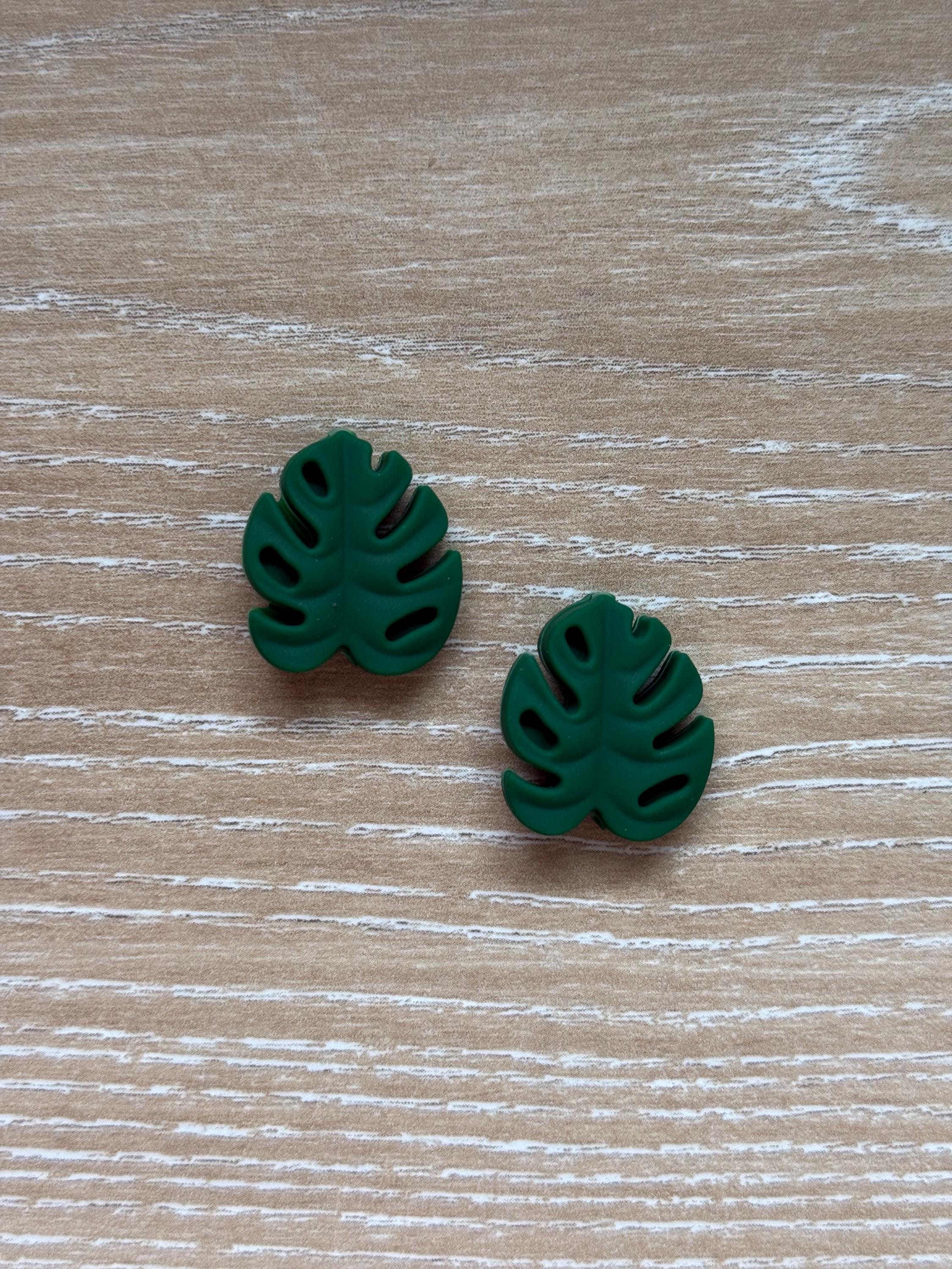 Leaf needle stoppers for knitting needles