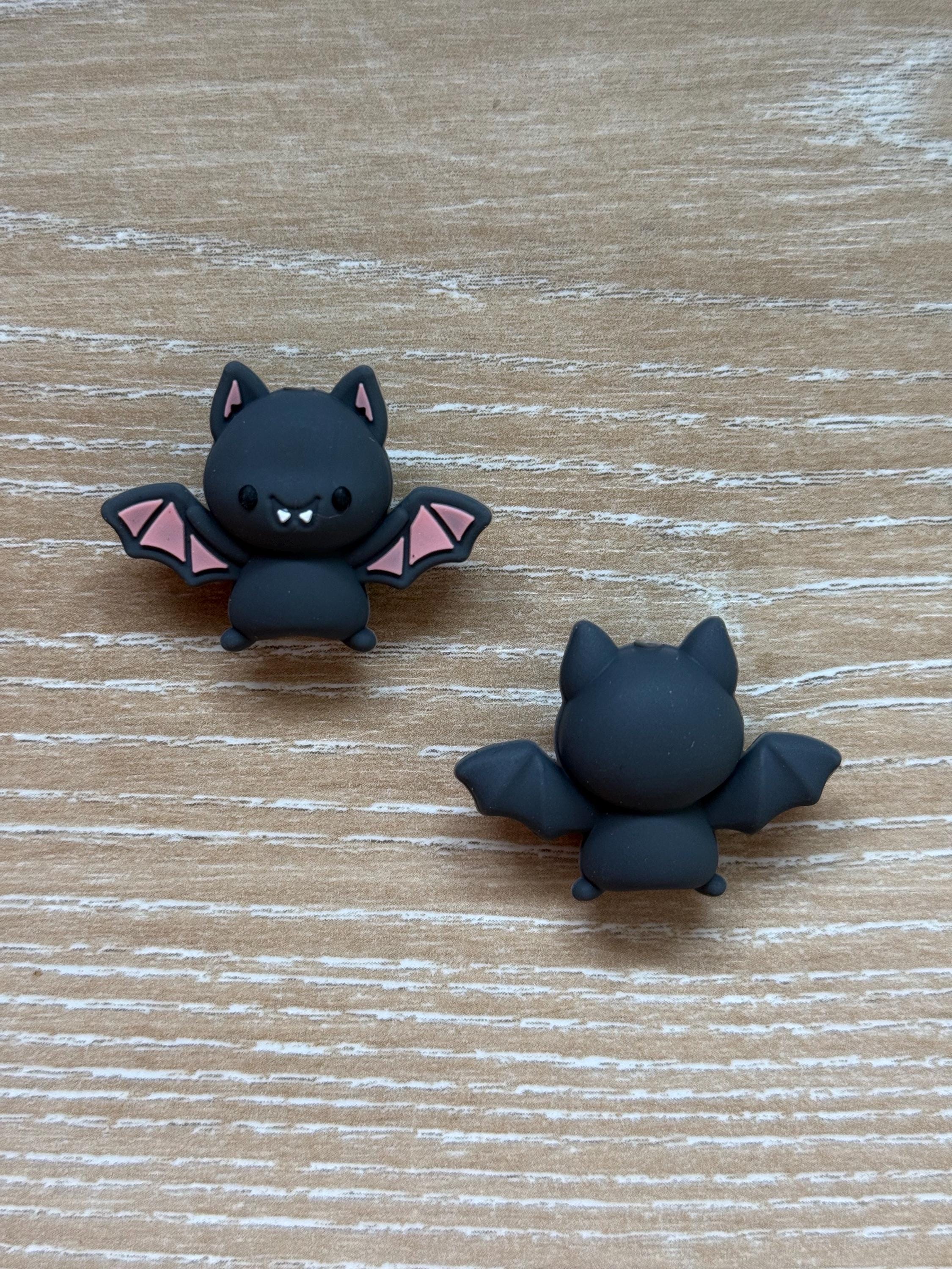 Bat needle stoppers for knitting needles