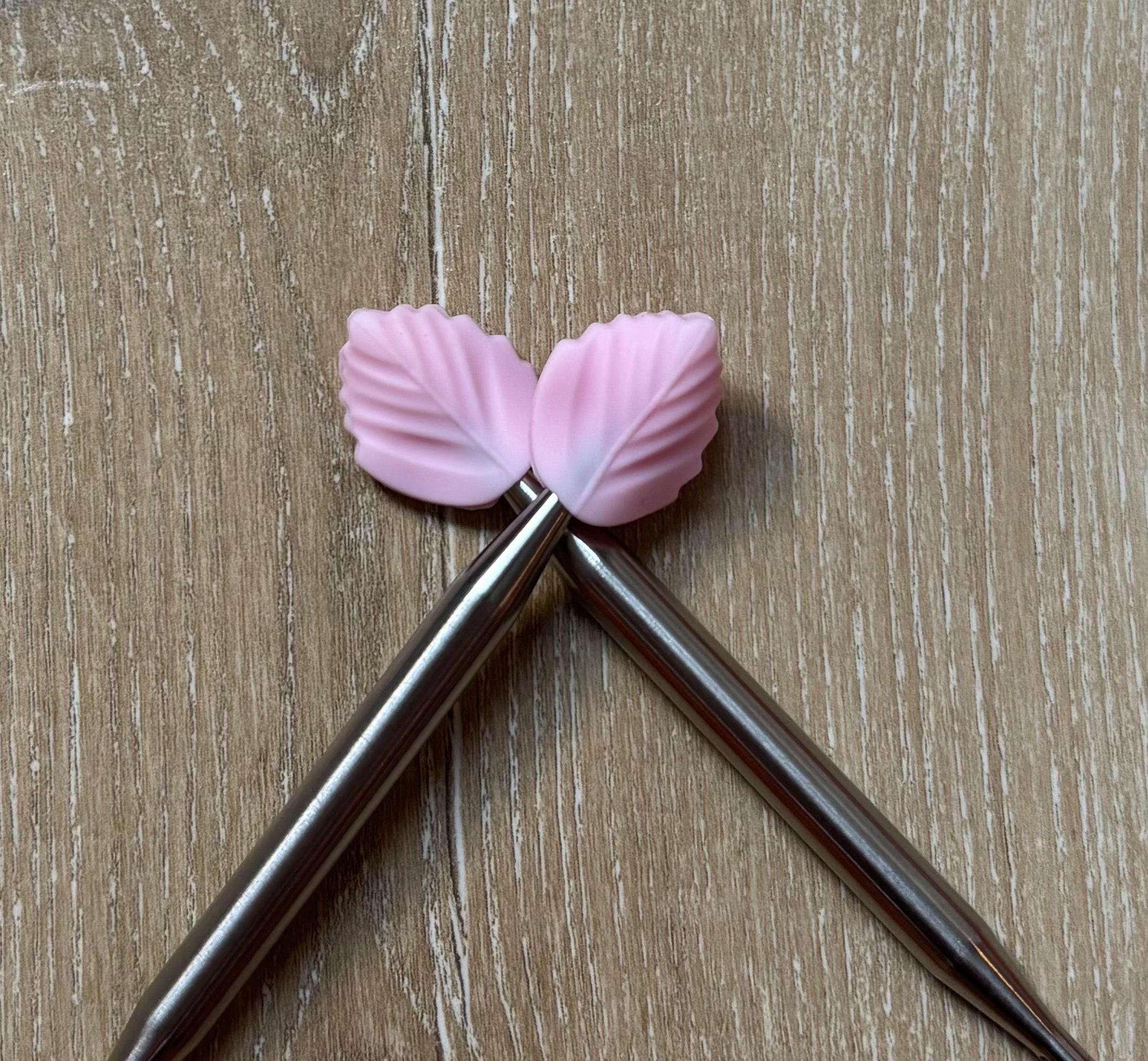 Leaf needle stoppers for knitting needles