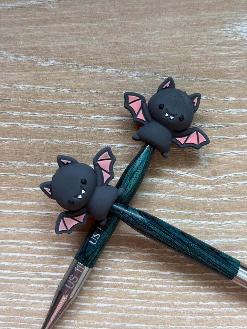 Bat needle stoppers for knitting needles